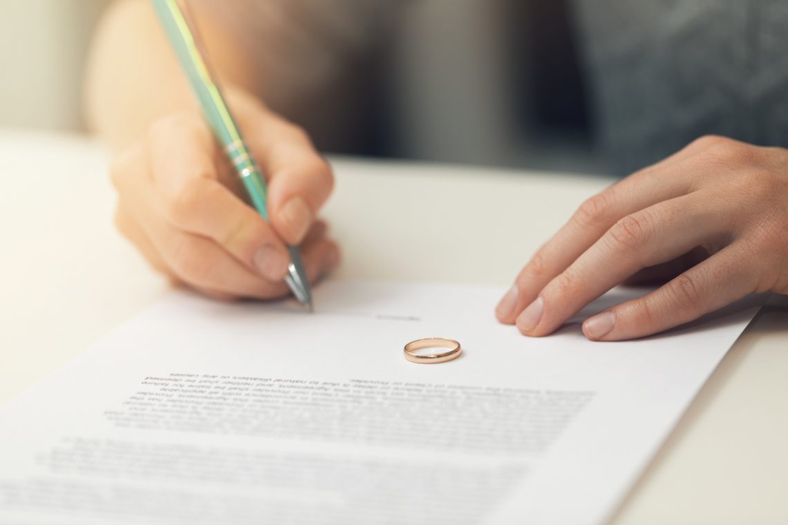 Woman Signing Marriage Documents