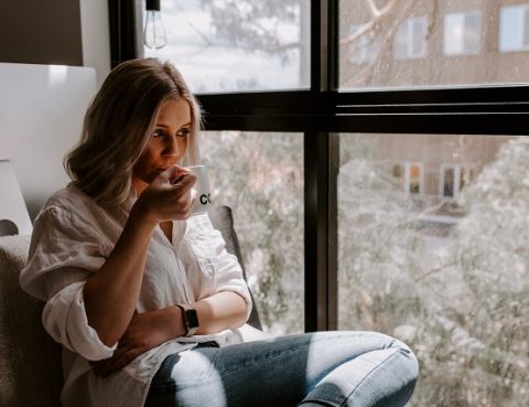 Woman Sipping Hot Drink Inside