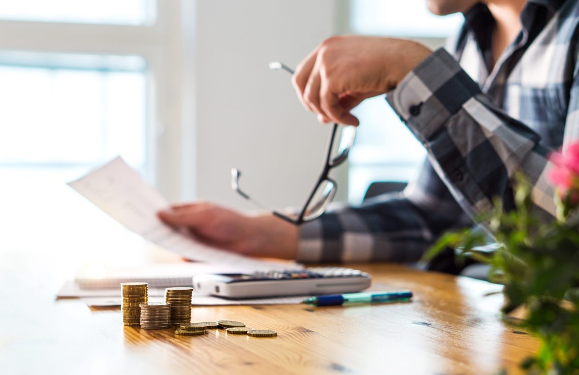 Stressed Man Reviewing Financial Documents