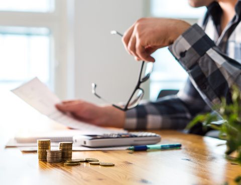 Stressed Man Reviewing Financial Documents